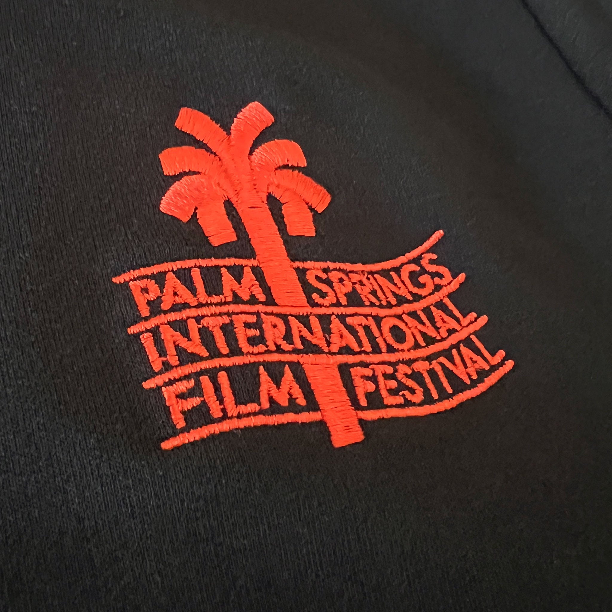 Embroidered logo of Palm Springs International Film Festival on a black background