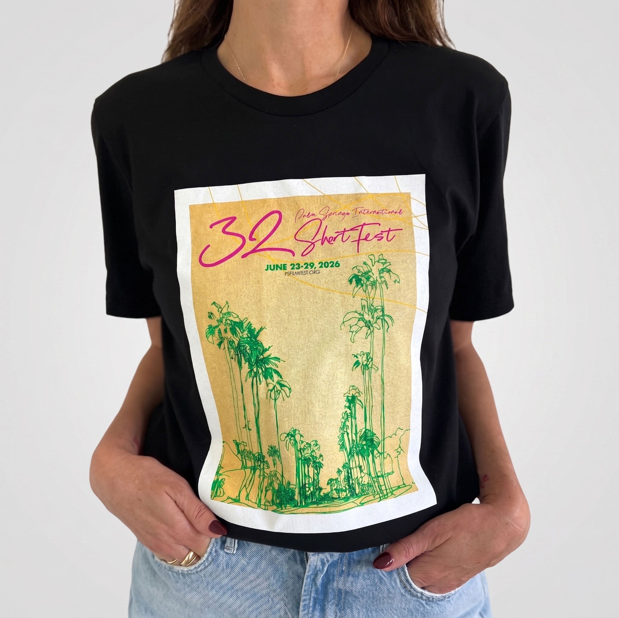 Black t-shirt with a graphic design featuring palm trees and text on a white background