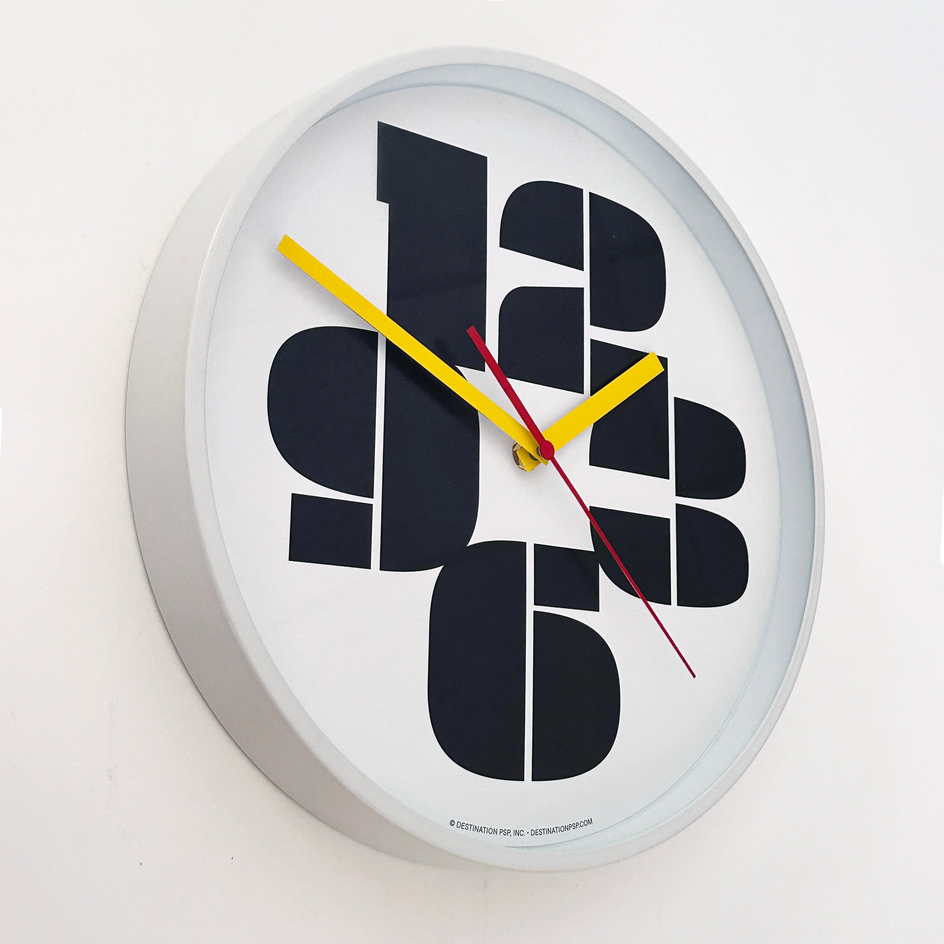 mod white wall clock with just the numbers 3, 6, 9, and 12