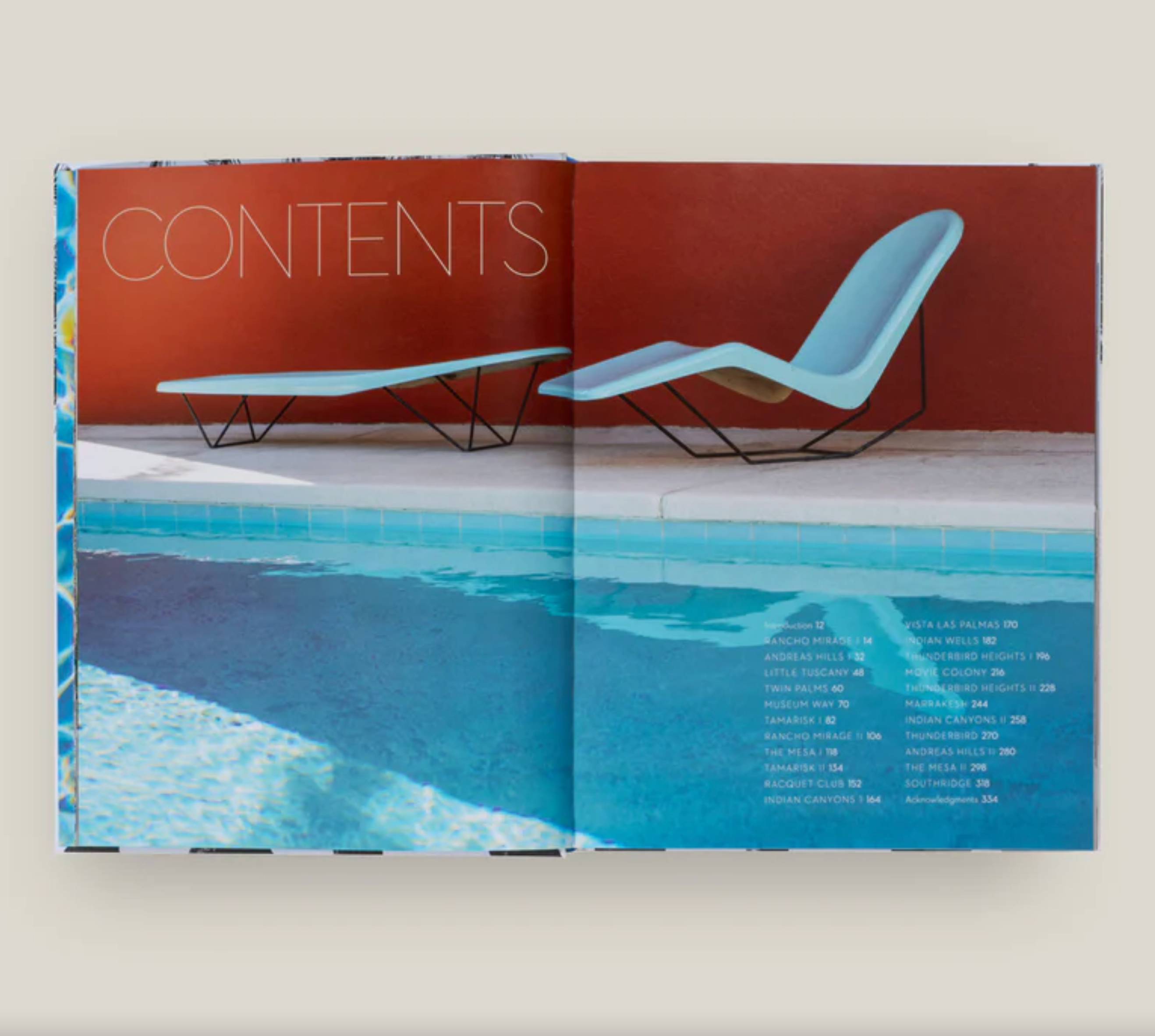 Open book showing a pool and lounge chair design on a white background