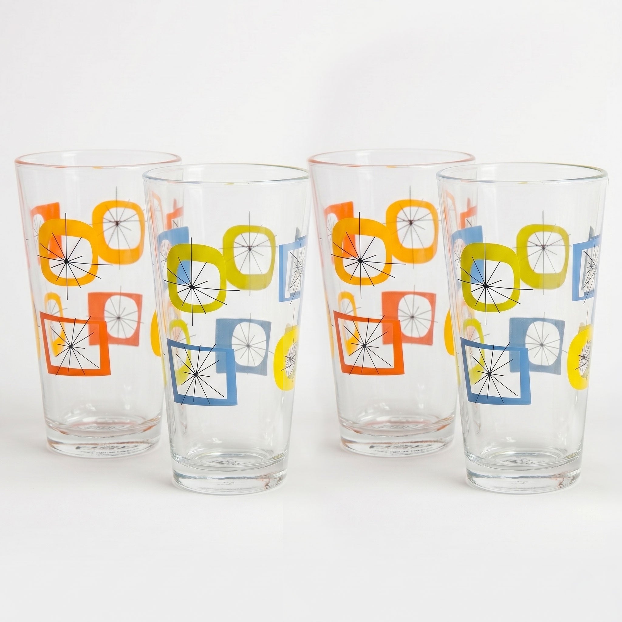 Four clear glasses with colorful geometric pattern on a white background