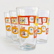 Set of four retro-style glasses with colorful geometric patterns on a white background
