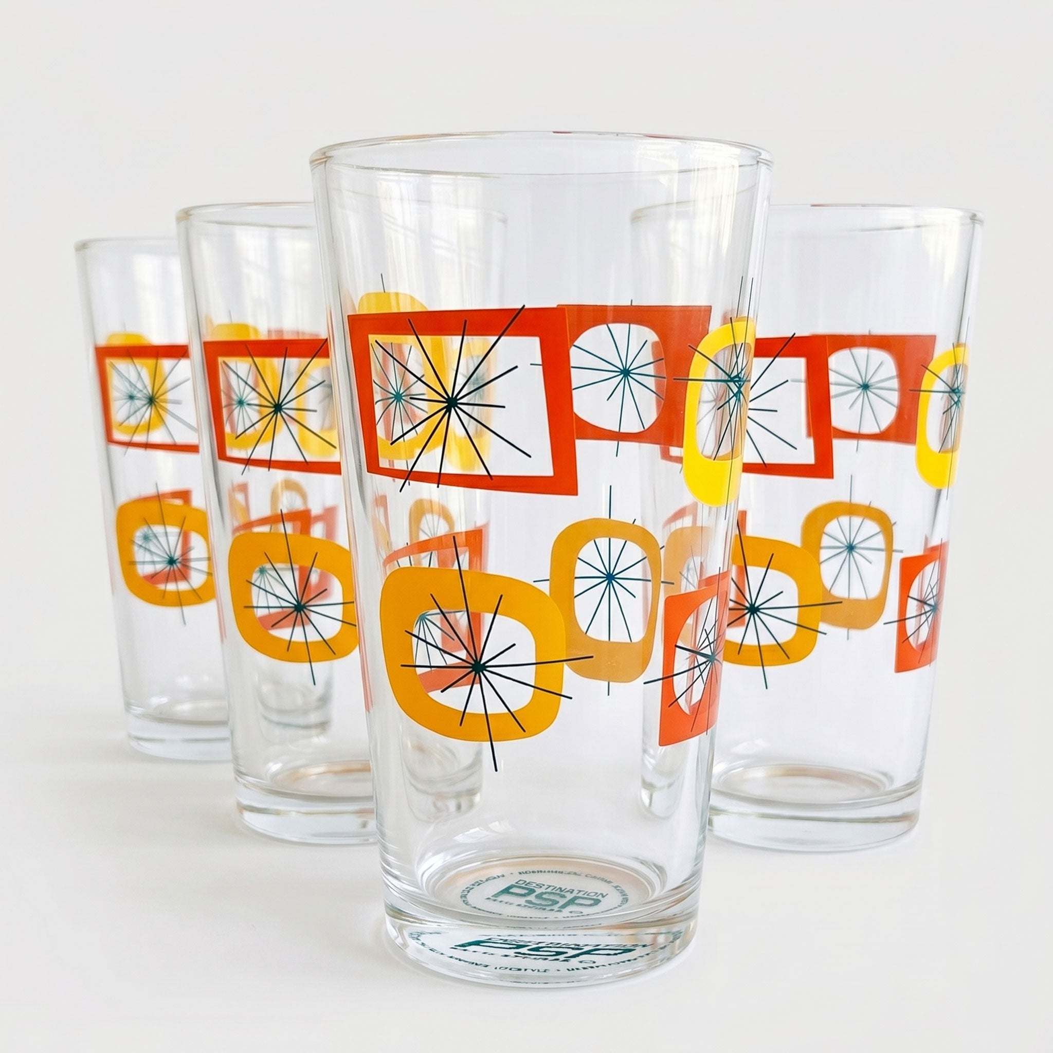 Set of four retro-style glasses with colorful geometric patterns on a white background