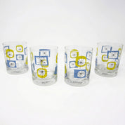 Four glass tumblers with geometric pattern on a white background
