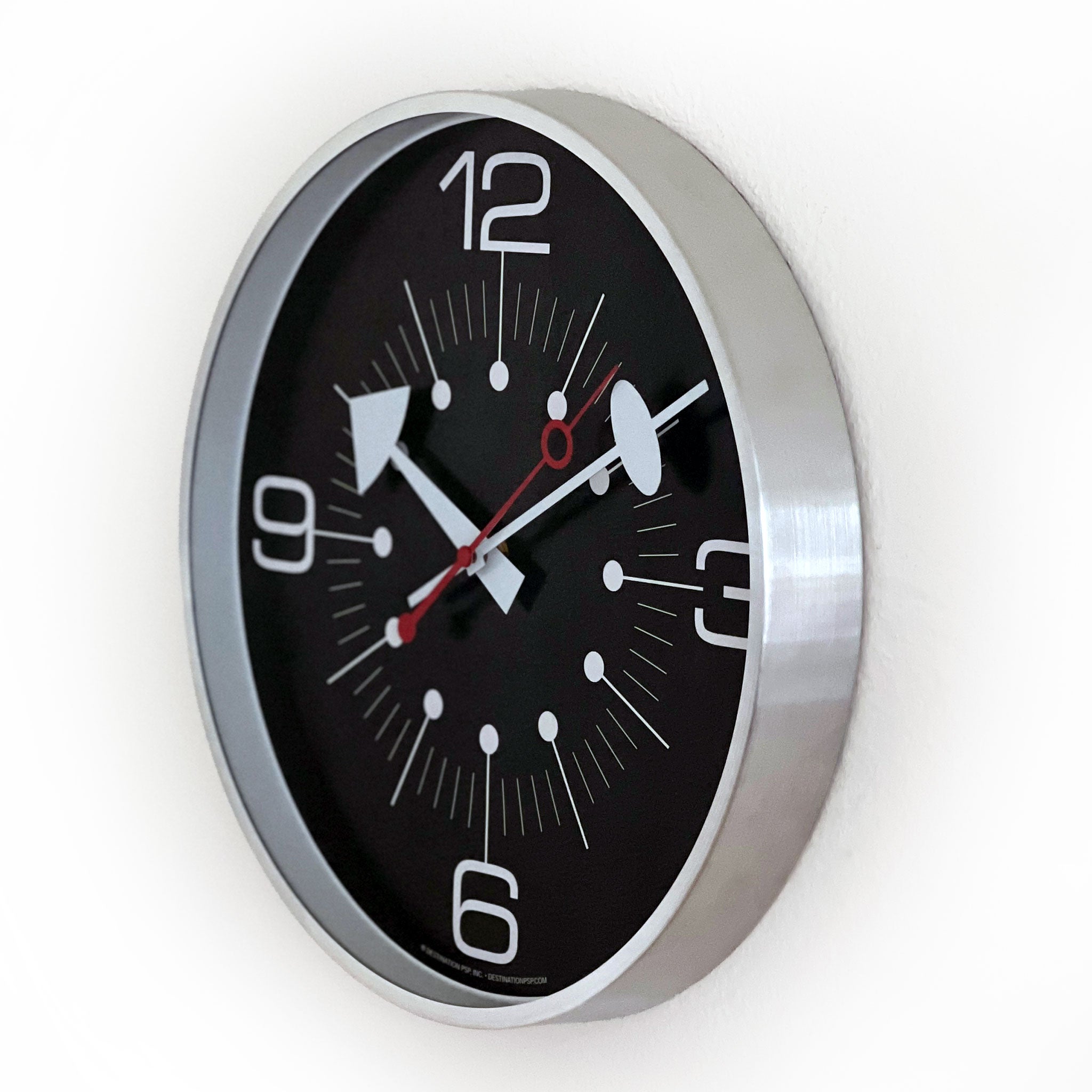 Wall clock with black face and silver frame on a white background