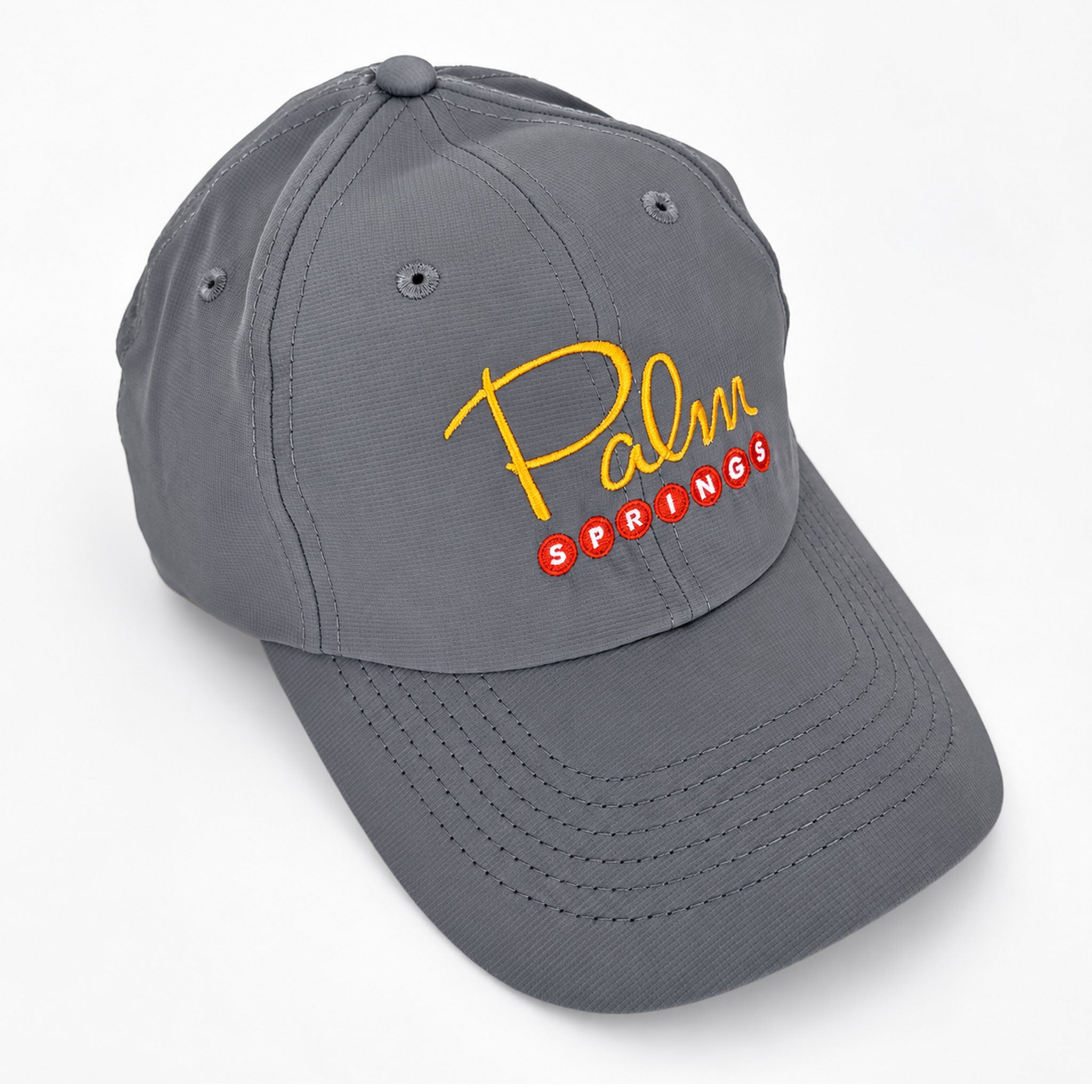 A gray baseball cap featuring a yellow embroidered 'Palm' script and red embroidered 'SPRINGS' text on the front, set against a clean white background.
