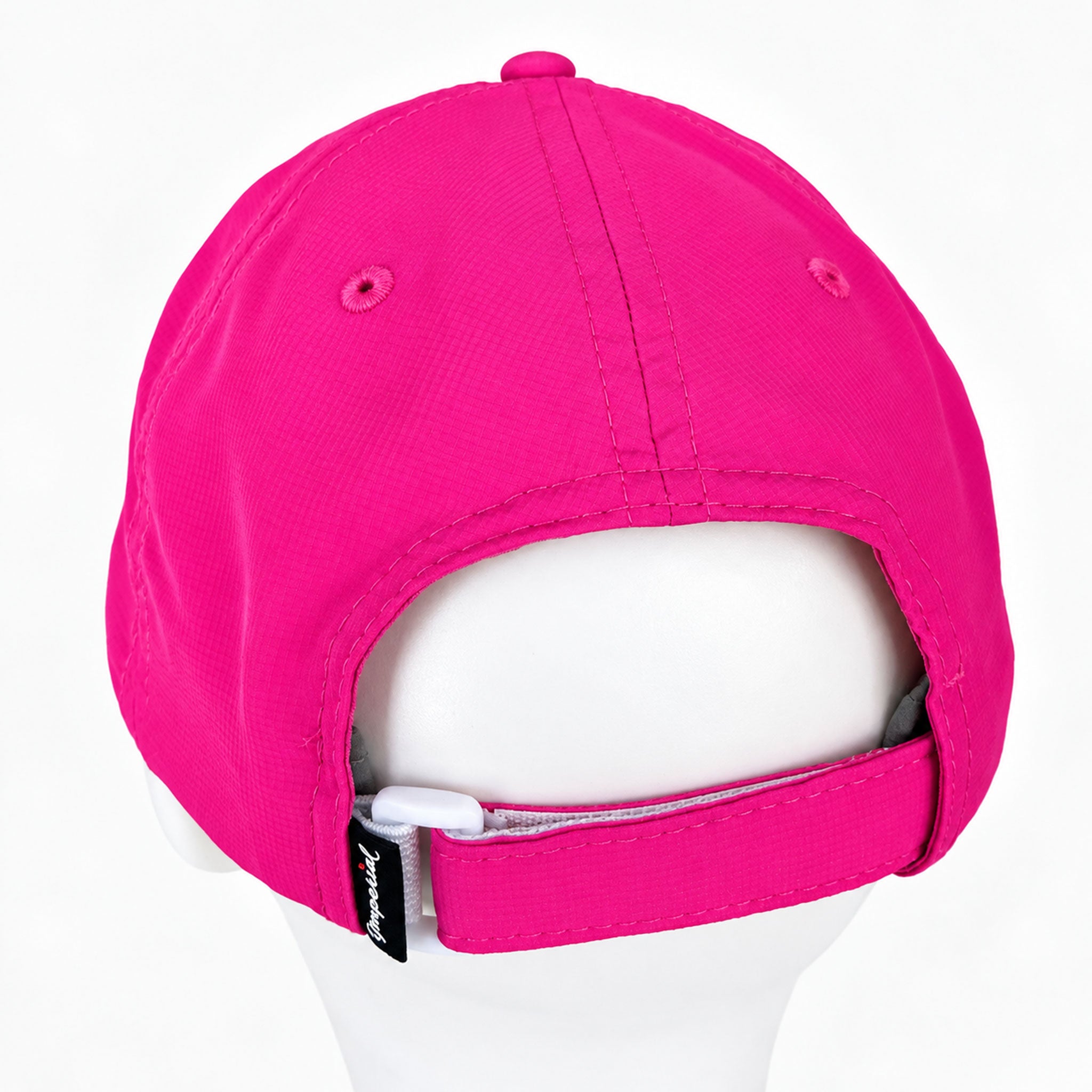 Bright pink baseball cap shown from the back on a white mannequin head, with an adjustable strap and small black brand tag visible.