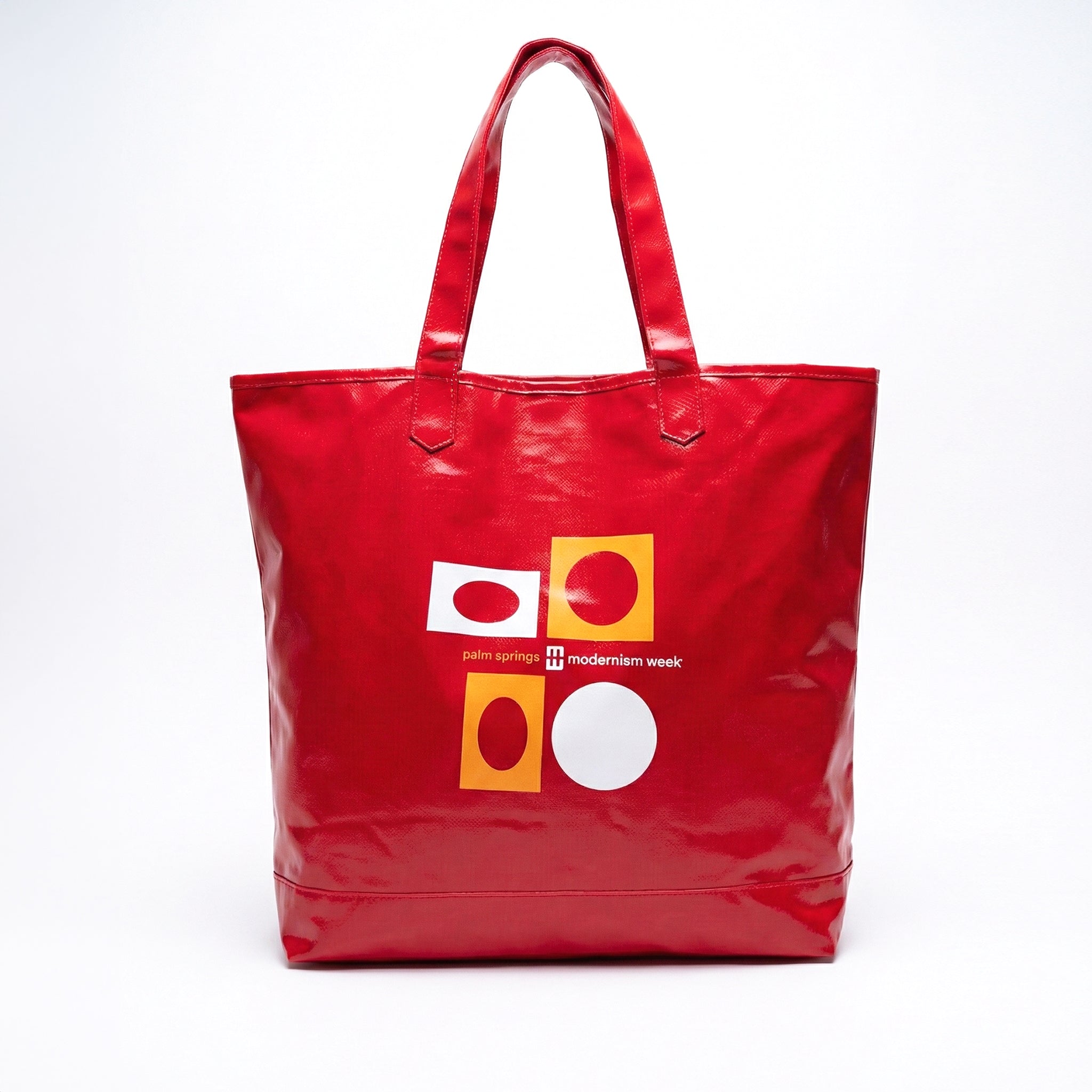 Red tote bag with geometric design on a white background