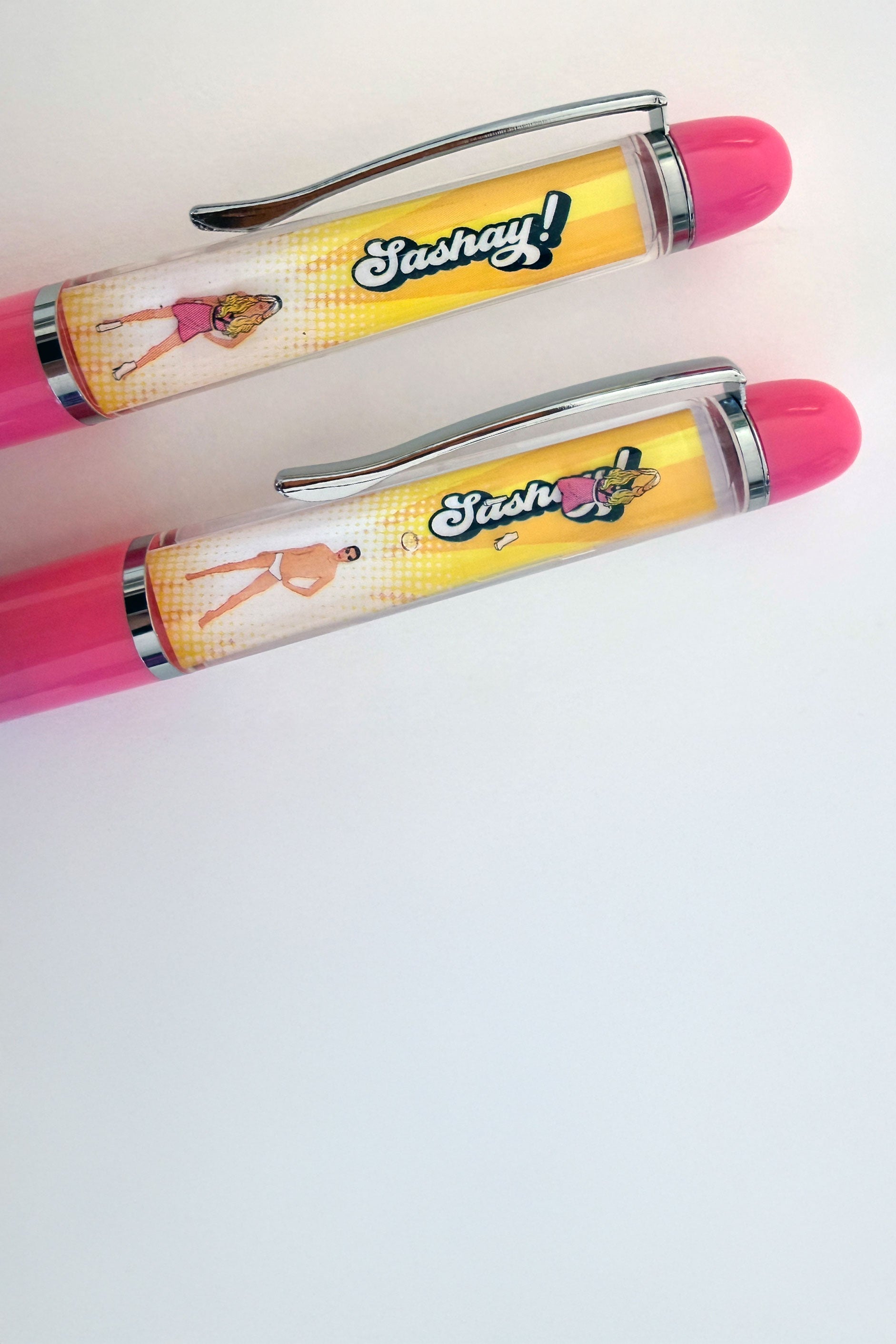 Two pink and yellow pens with 'Sashay' branding on a white background
