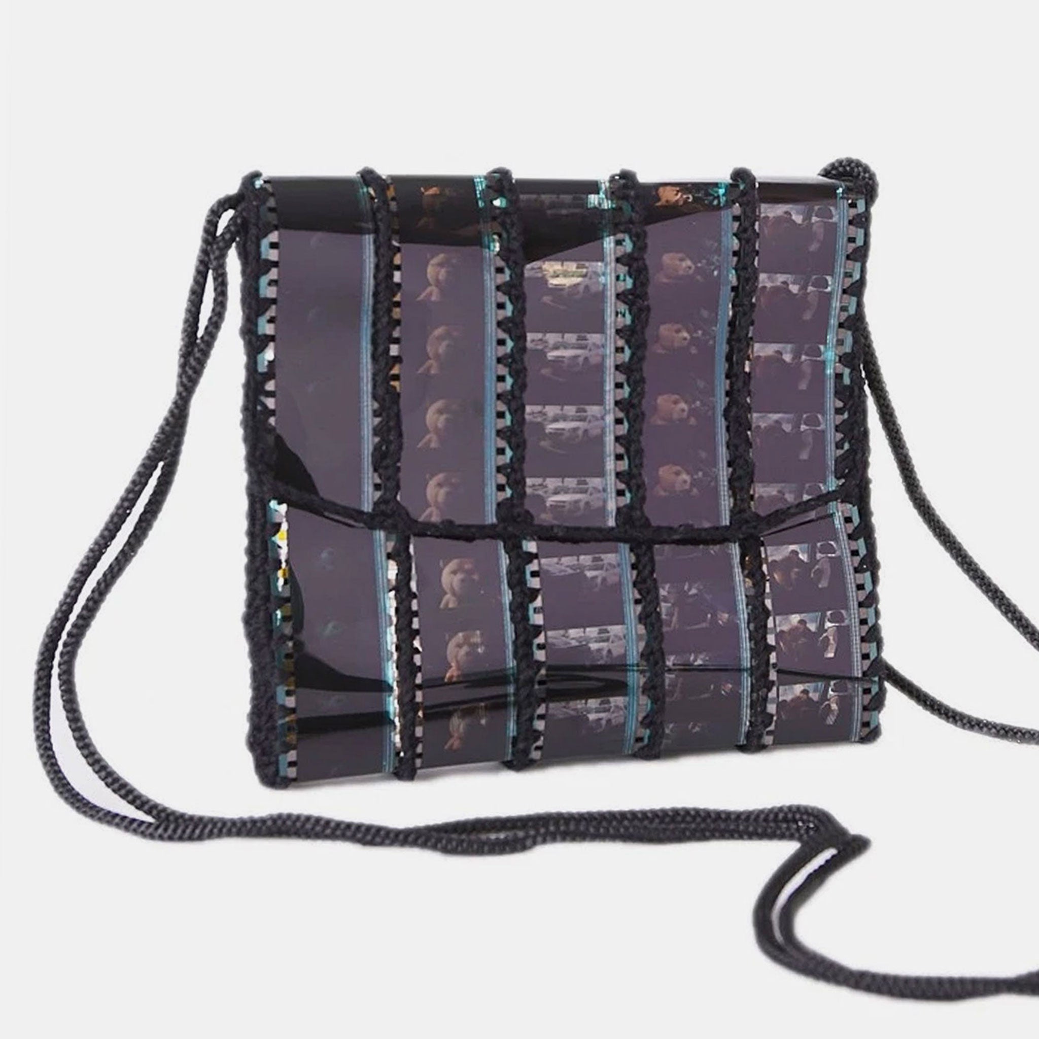 Handbag with film strip pattern on a light gray background