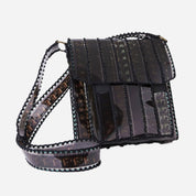 Black film strip handbag on a white background