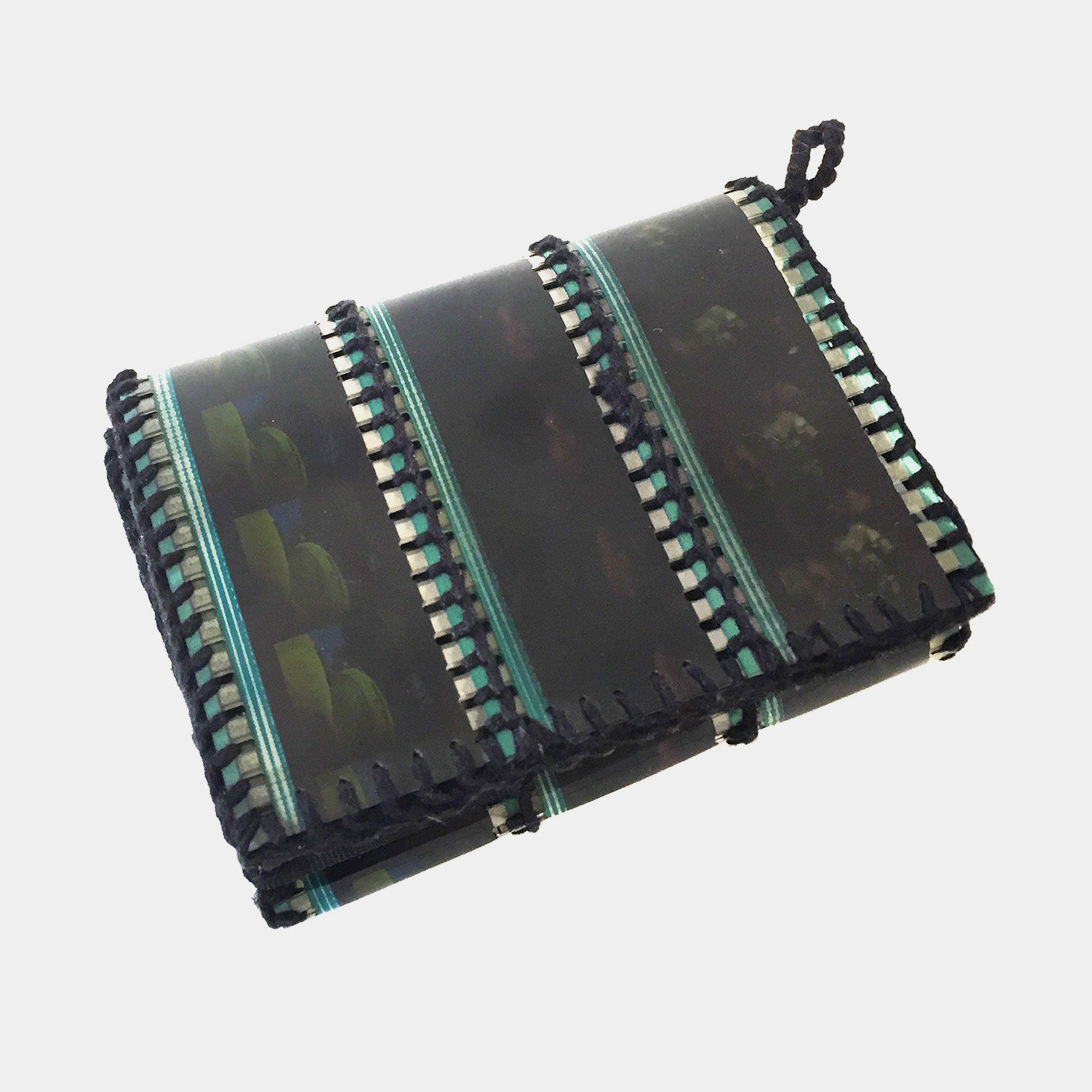 Foldable black and green mat with textured pattern on a white background