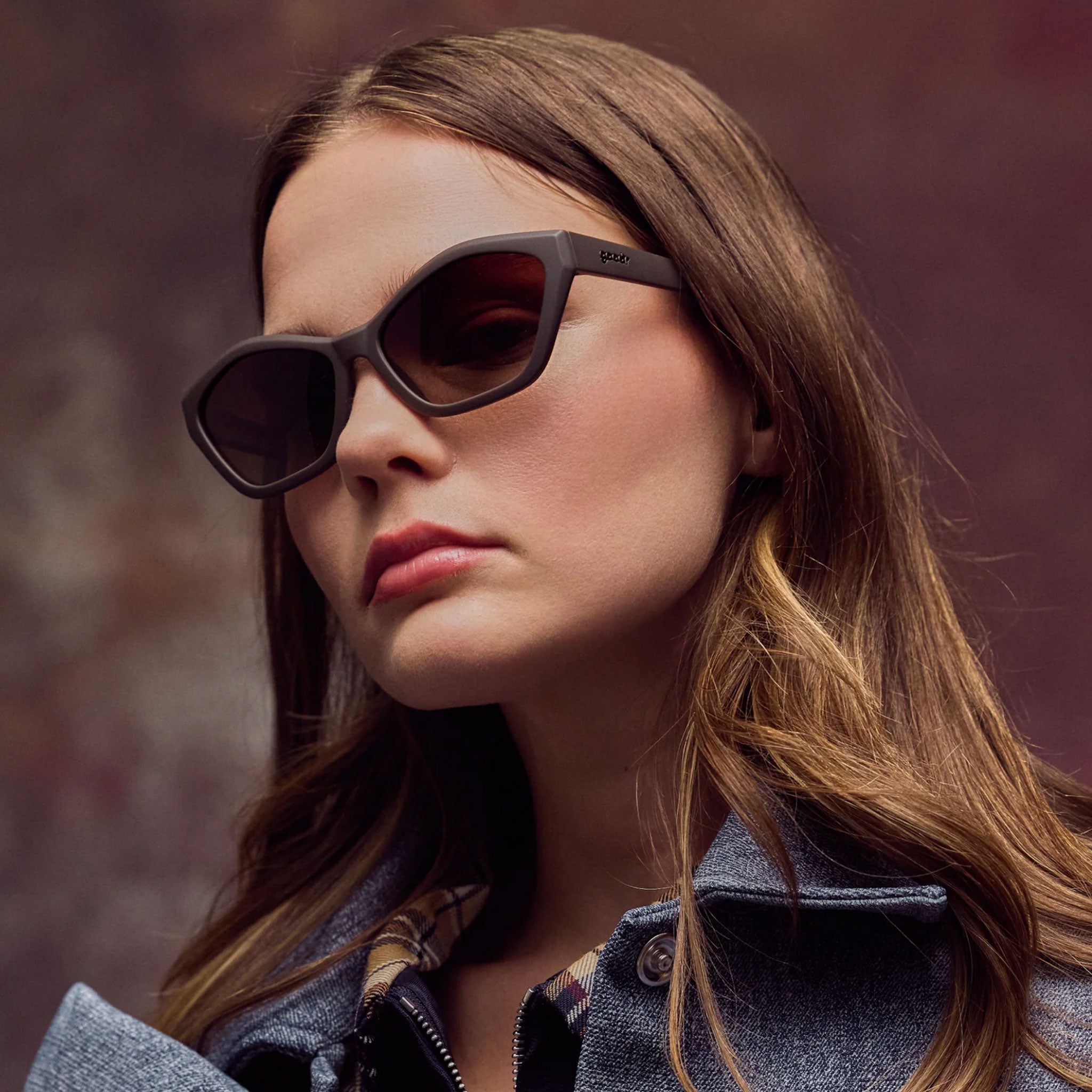 A woman wearing brown sunglasses
