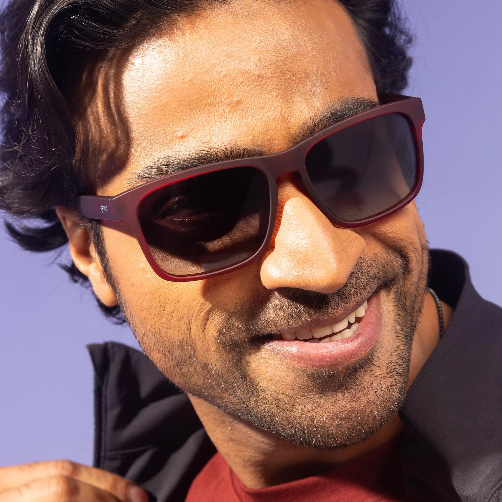 Man wearing sunglasses with a blurred background