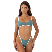 Woman wearing a teal and white bikini on a white background