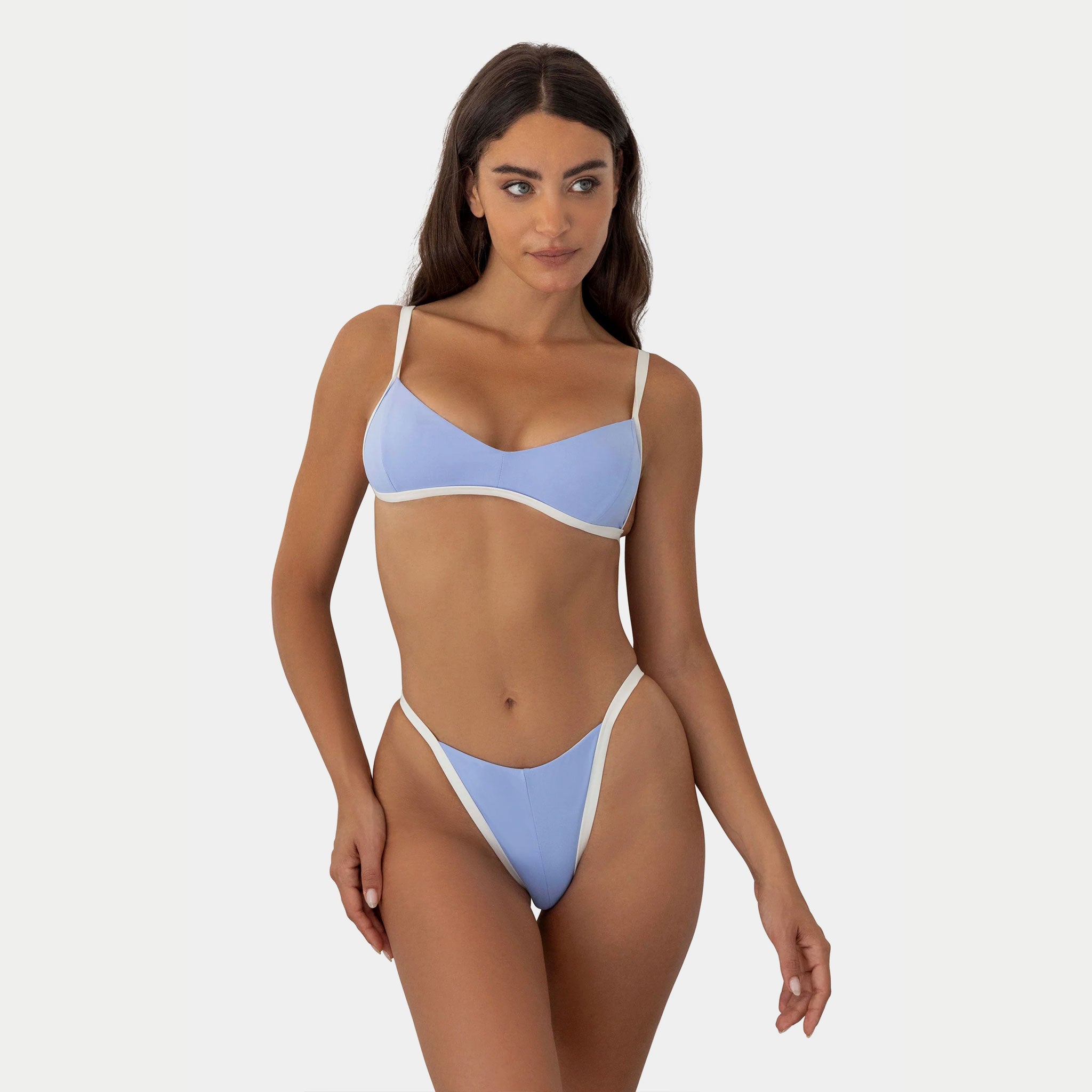 Woman wearing a light blue bikini on a white background