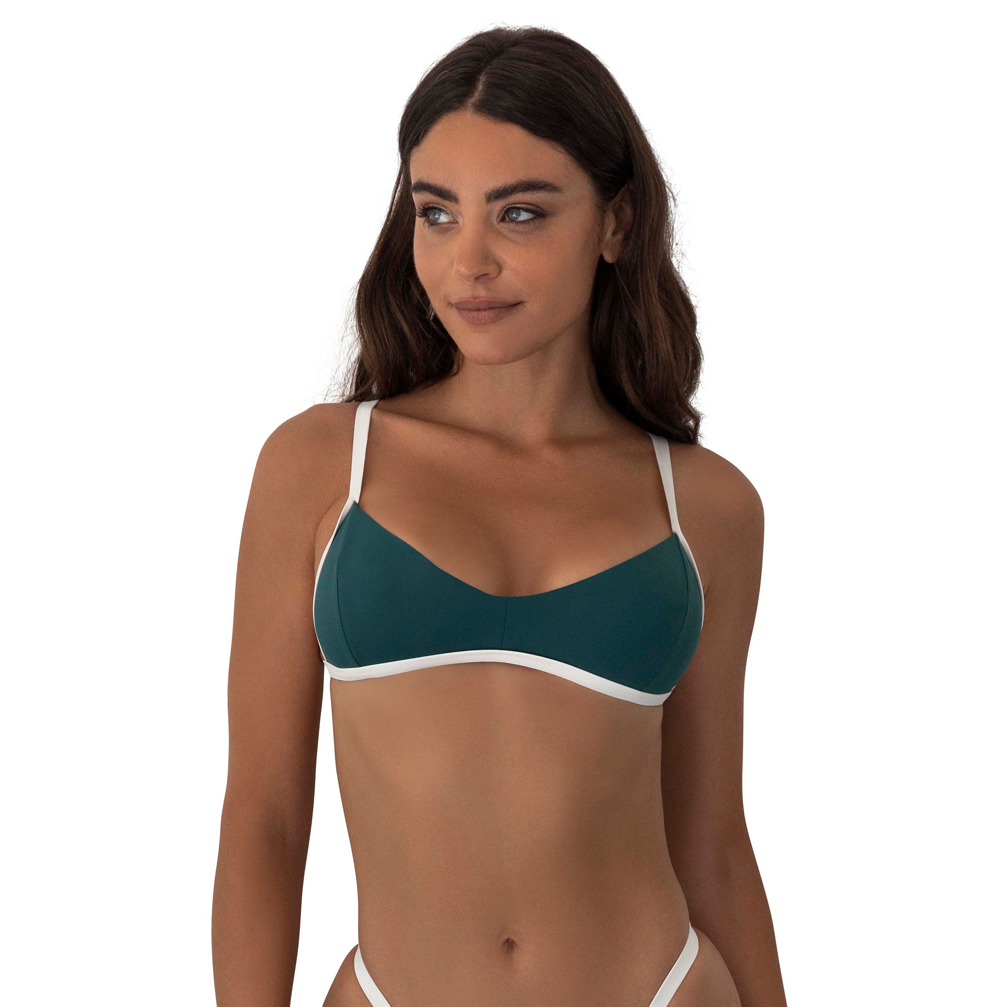 Woman wearing a green bikini top with white straps on a white background