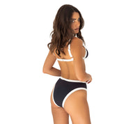 Woman wearing a black and white bikini on a white background