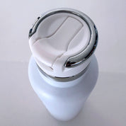 White ceramic vase with a silver base on a light gray background