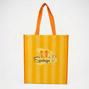Yellow and orange striped tote bag with 'Palm Springs' logo on a white background